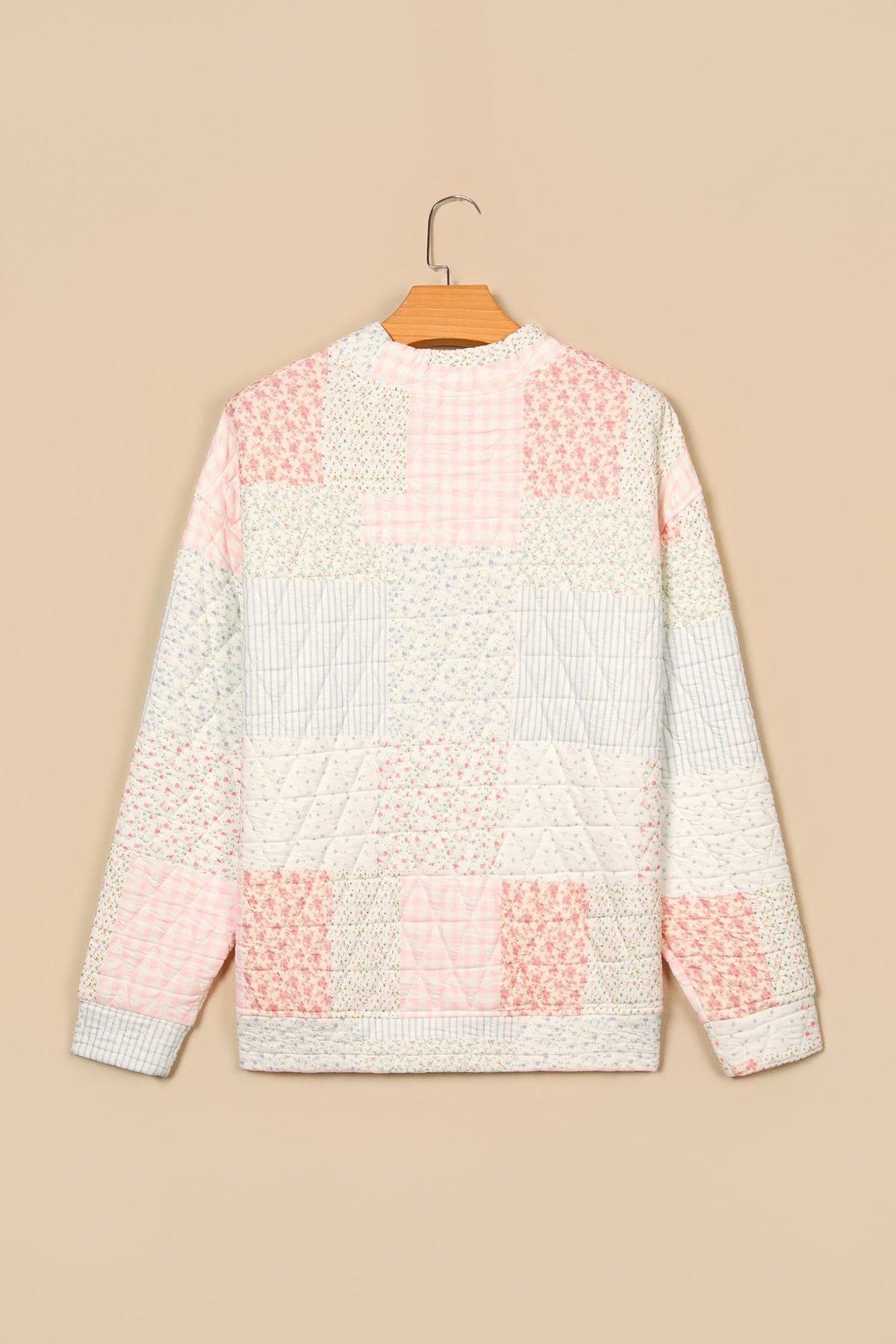 Floral patchwork quilted mock neck long sleeve top, multicolour, back view on hanger