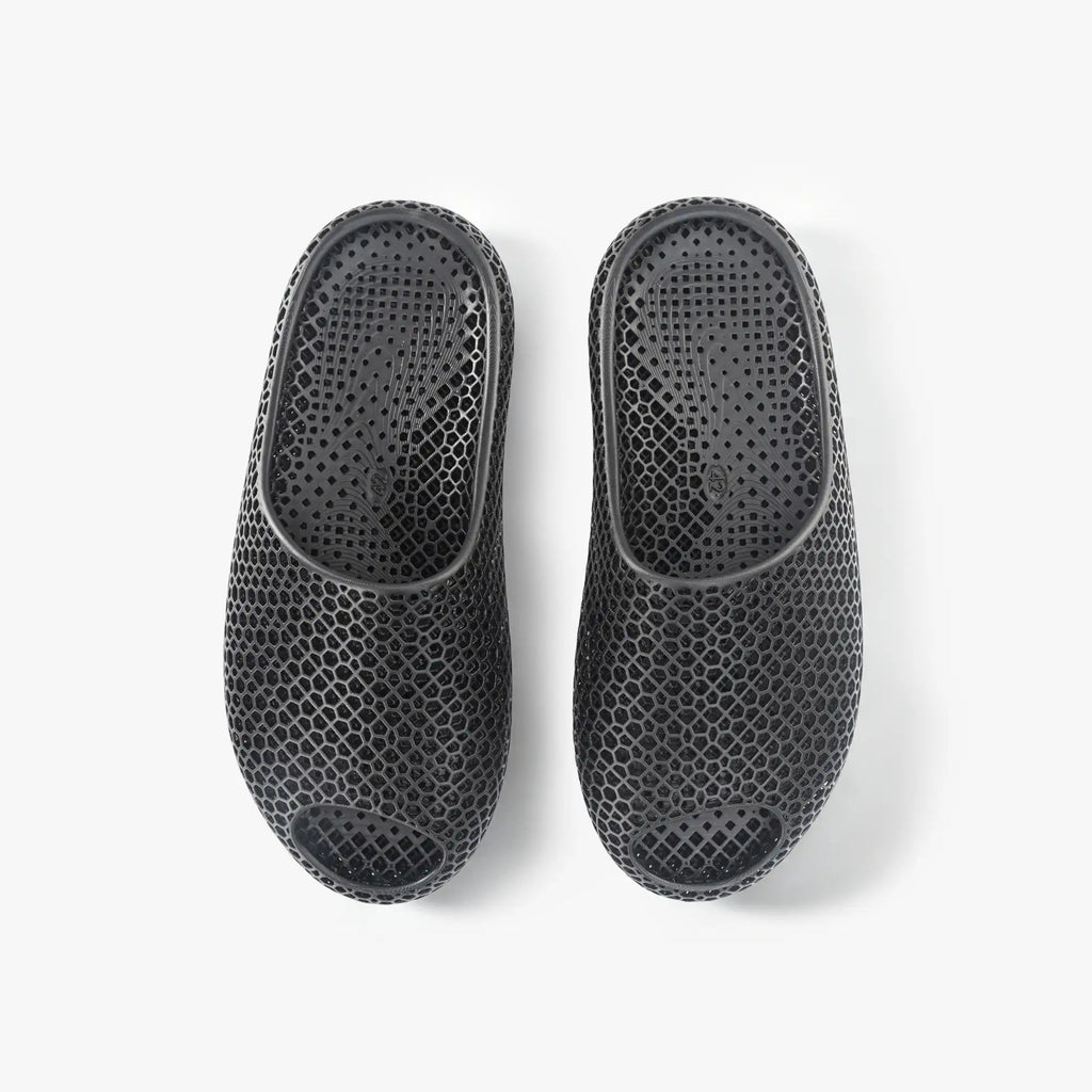 Black 3D-printed mesh slippers, pair showing back and side openings.