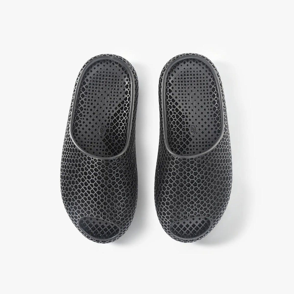 Black 3D-printed mesh slippers, pair showing back and side openings.