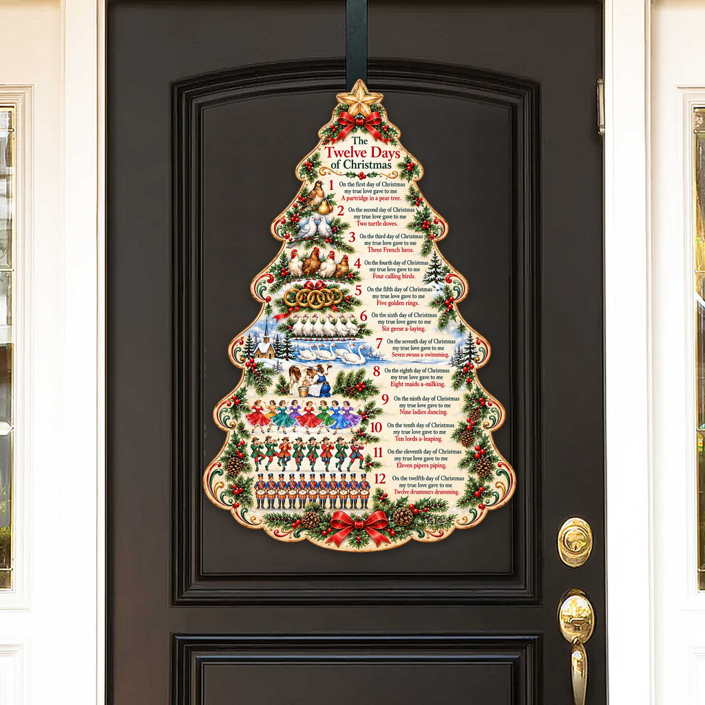 Christmas tree wooden door hanger displayed on a dark framed door with star topper