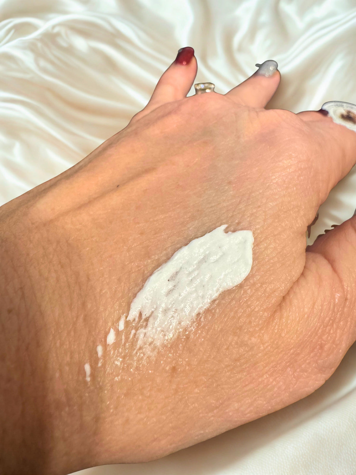 Whipped tallow body butter spread on forearm skin