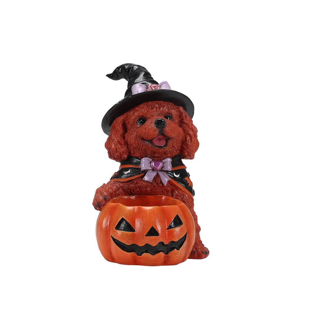 Front view of a brown dog witch figurine holding an empty jack-o'-lantern bowl