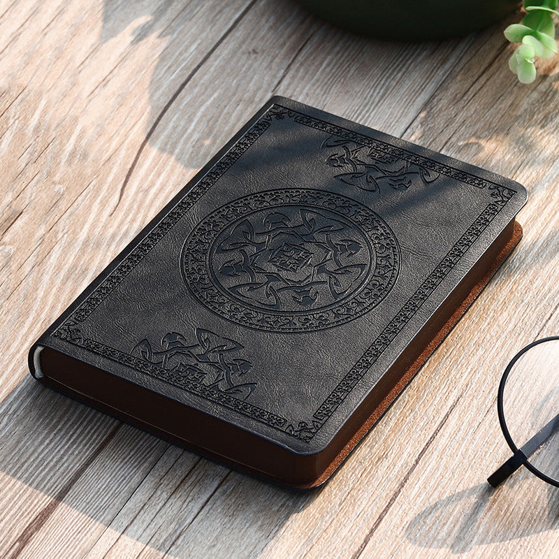 A6 leather mini notebook with embossed circular emblem on grey cover
