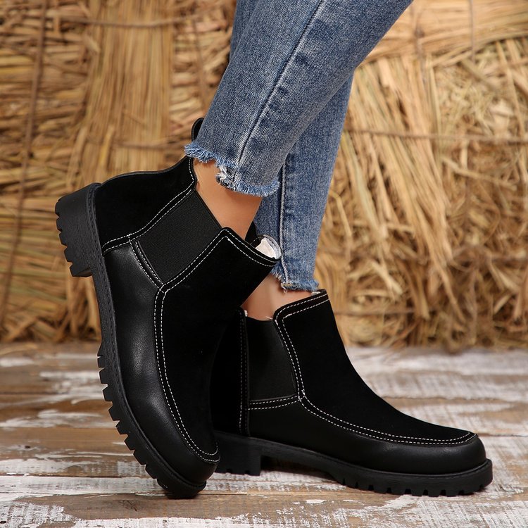 Black platform ankle boots with rounded toe, side gussets, and chunky sole