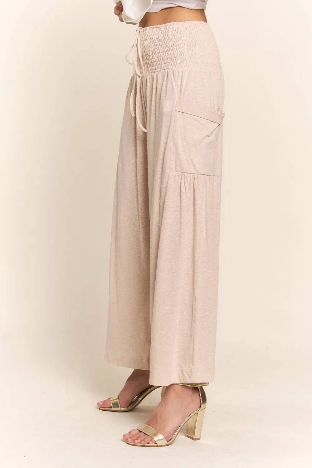 Light beige smocked-waist wide-leg pants with side patch pockets