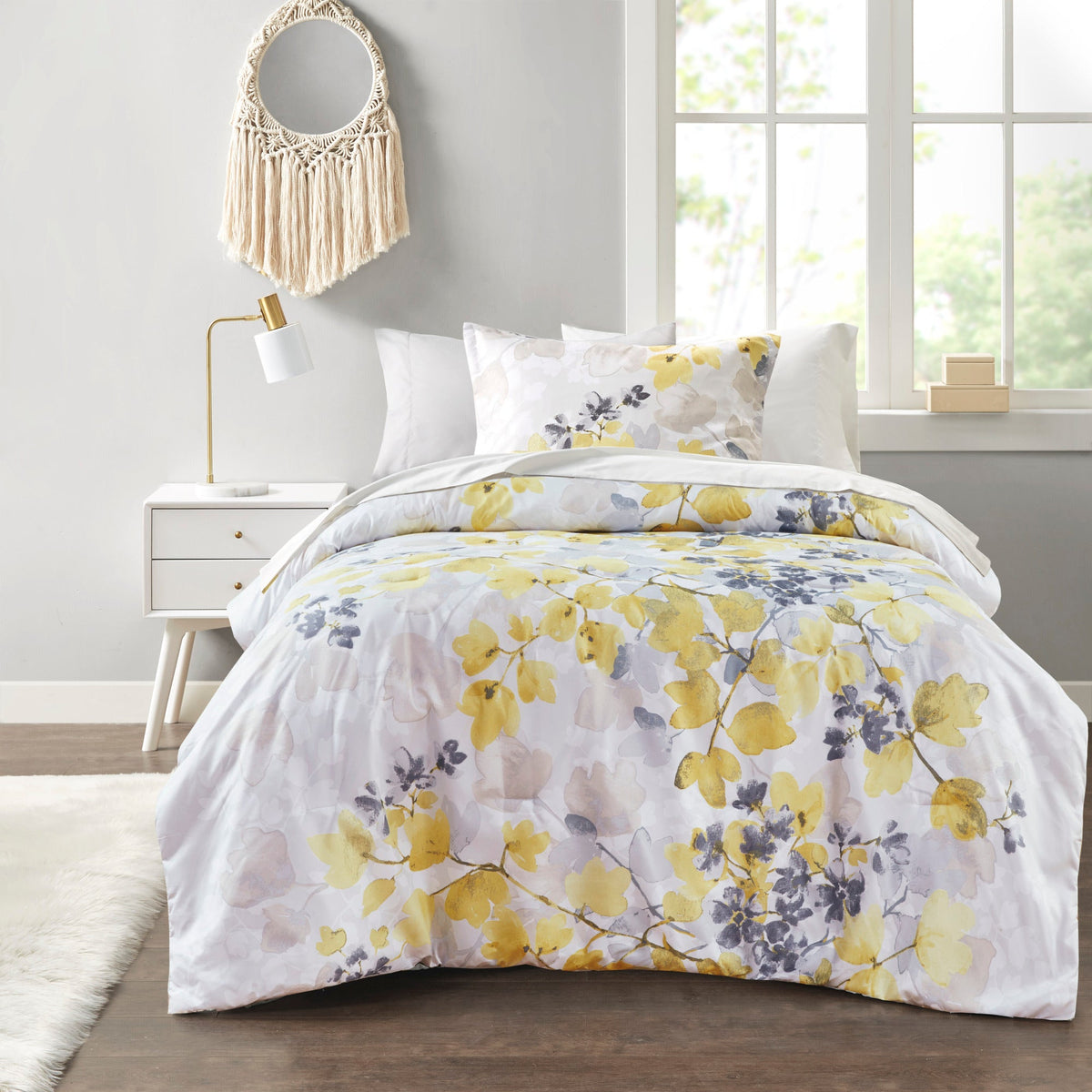 Twin XL comforter set with white sheets and multicolor floral comforter in yellow and gray