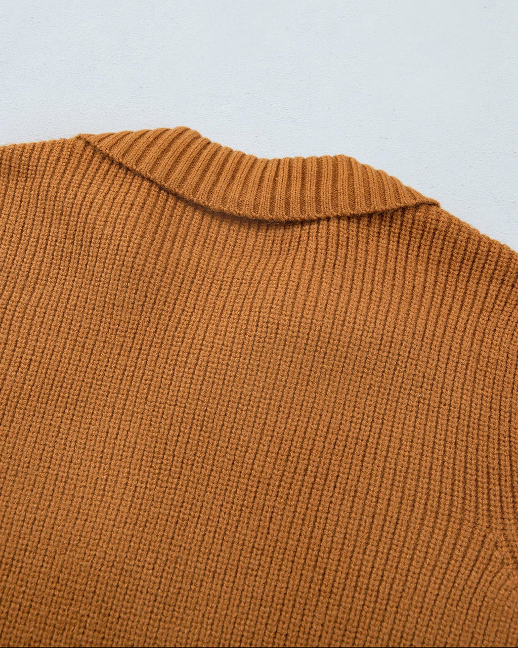 Back view of tan ribbed knit cardigan with wide ribbed collar