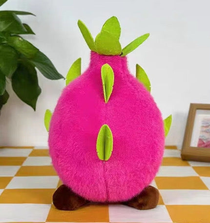 Back view of pink dragon fruit plush toy with green leaves and brown feet