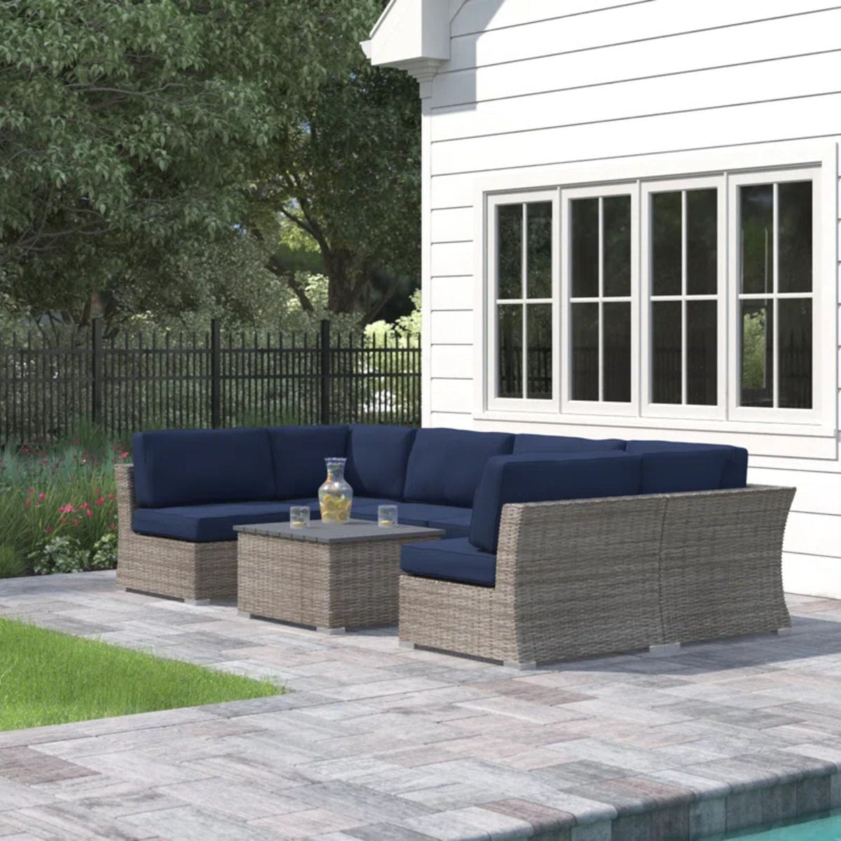 Outdoor wicker sectional sofa with blue cushions and built-in coffee table