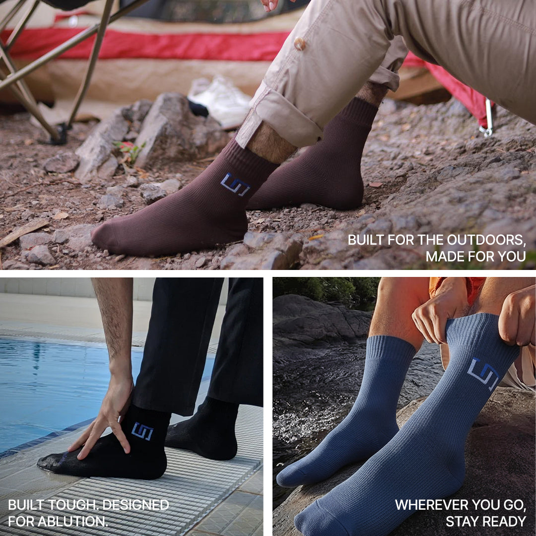 Dark and navy blue crew socks with blue logo patches, worn outdoors