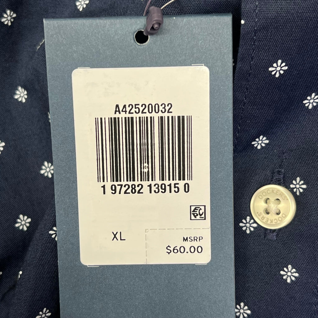 Navy shirt with white daisy pattern and barcode size tag marked XL.