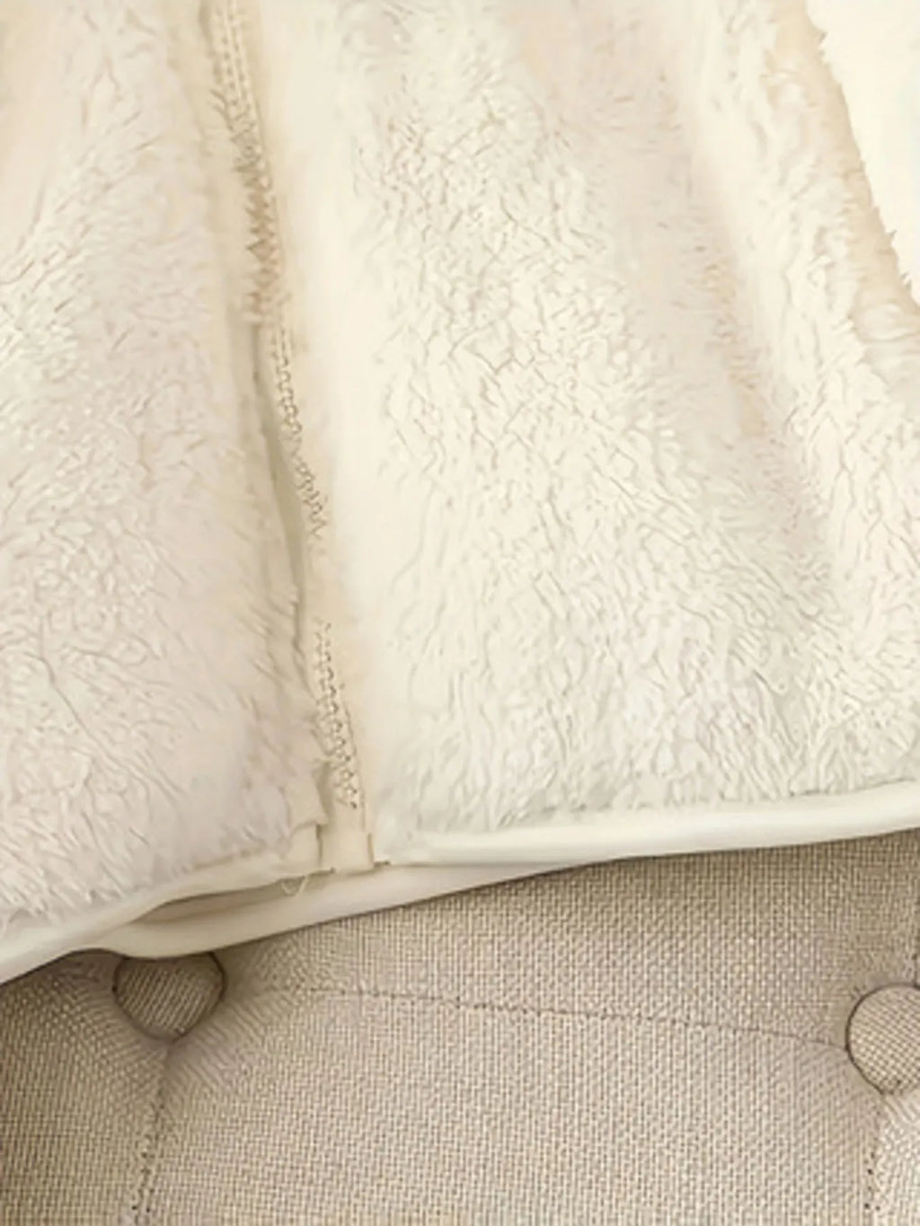 White fleece jacket hem with front zipper seam detail