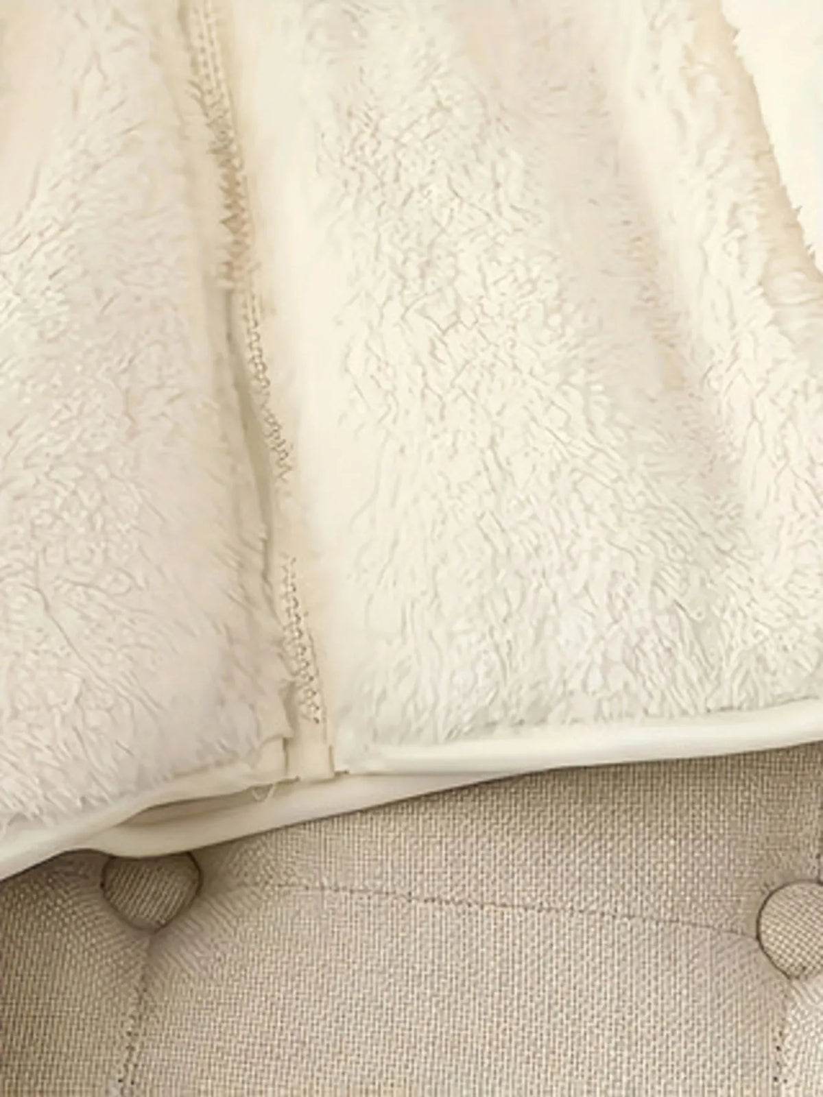 White fleece jacket hem with front zipper seam detail