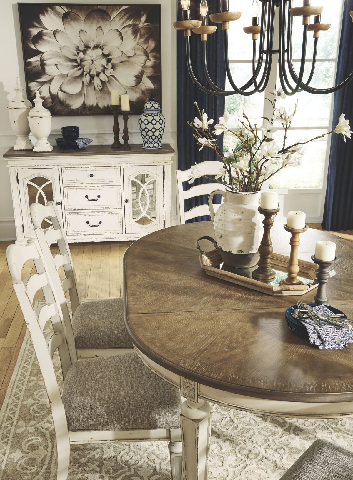 White oval dining table with four ladderback chairs and taupe upholstered seats