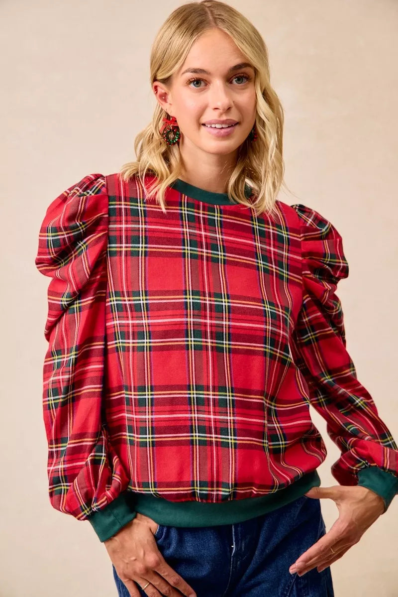 Red plaid top with exaggerated shoulder sleeves, green cuffs, and crew neck