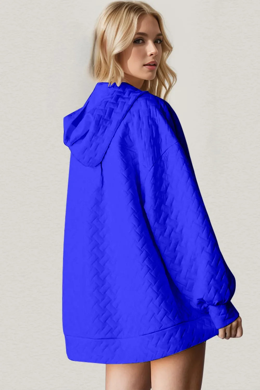Royal blue textured hoodie with hood and long sleeves, side view