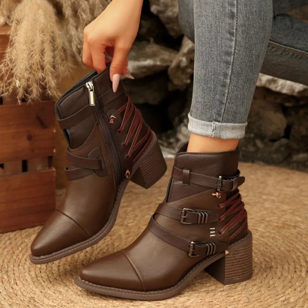 Dark brown ankle boots with point toe, buckle straps, and block heels