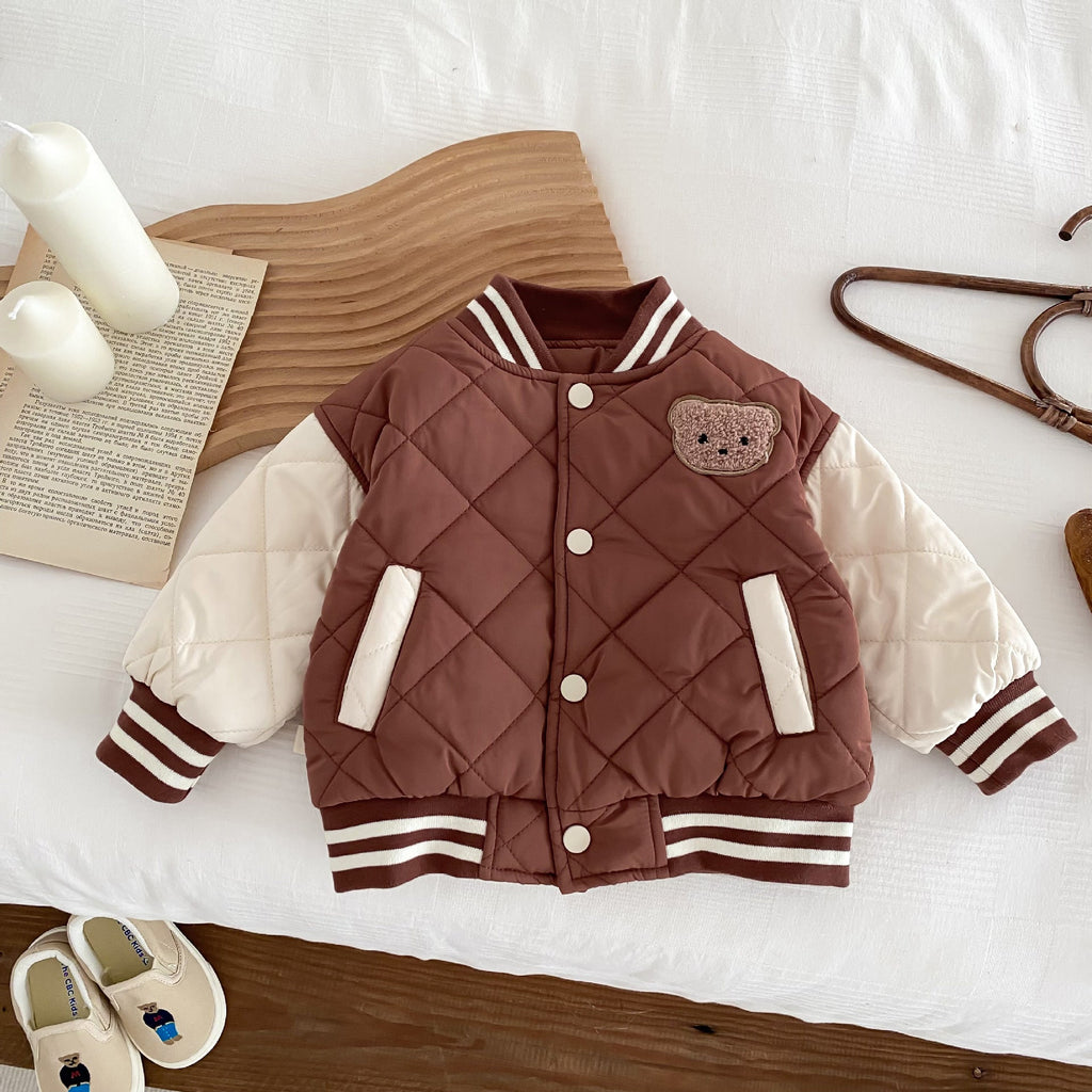 Kids reddish-brown quilted baseball jacket with bear patch, snap buttons, striped hem and cuffs