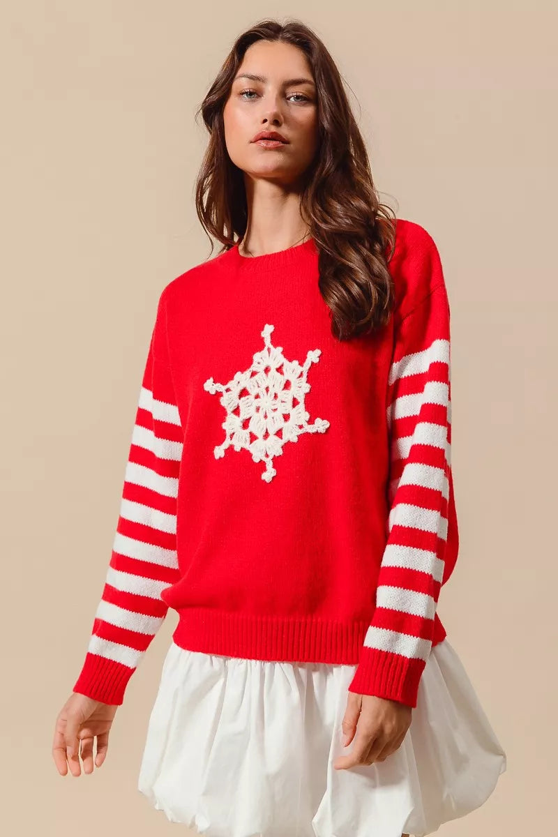 Red sweater with white crochet snowflake applique and red-and-ivory striped arm bands