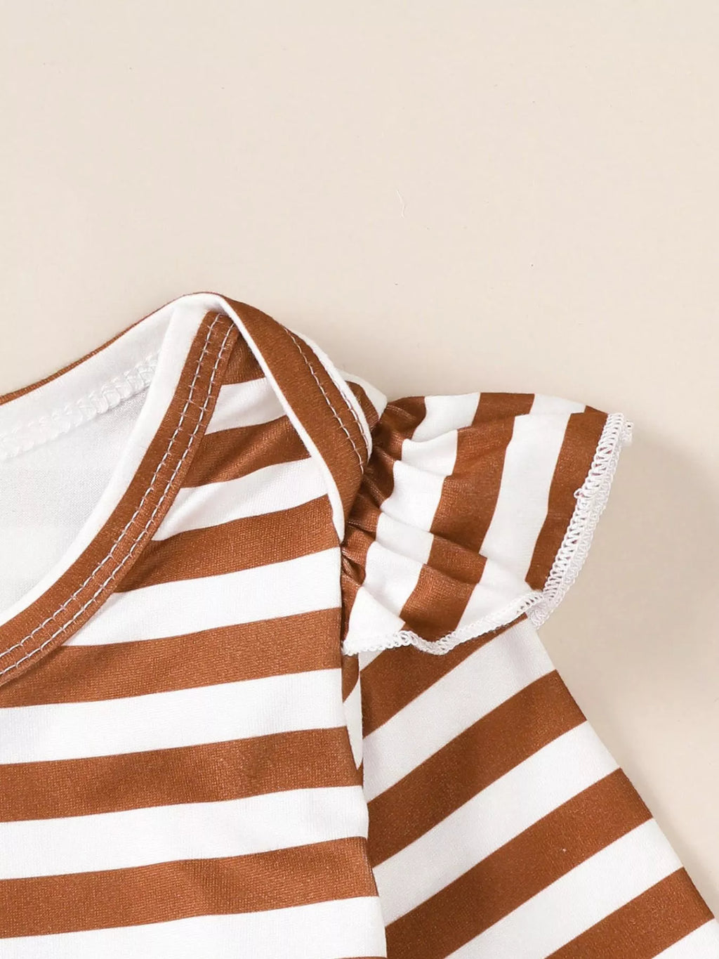 Brown-and-white striped bodysuit sleeve and neckline seam detail