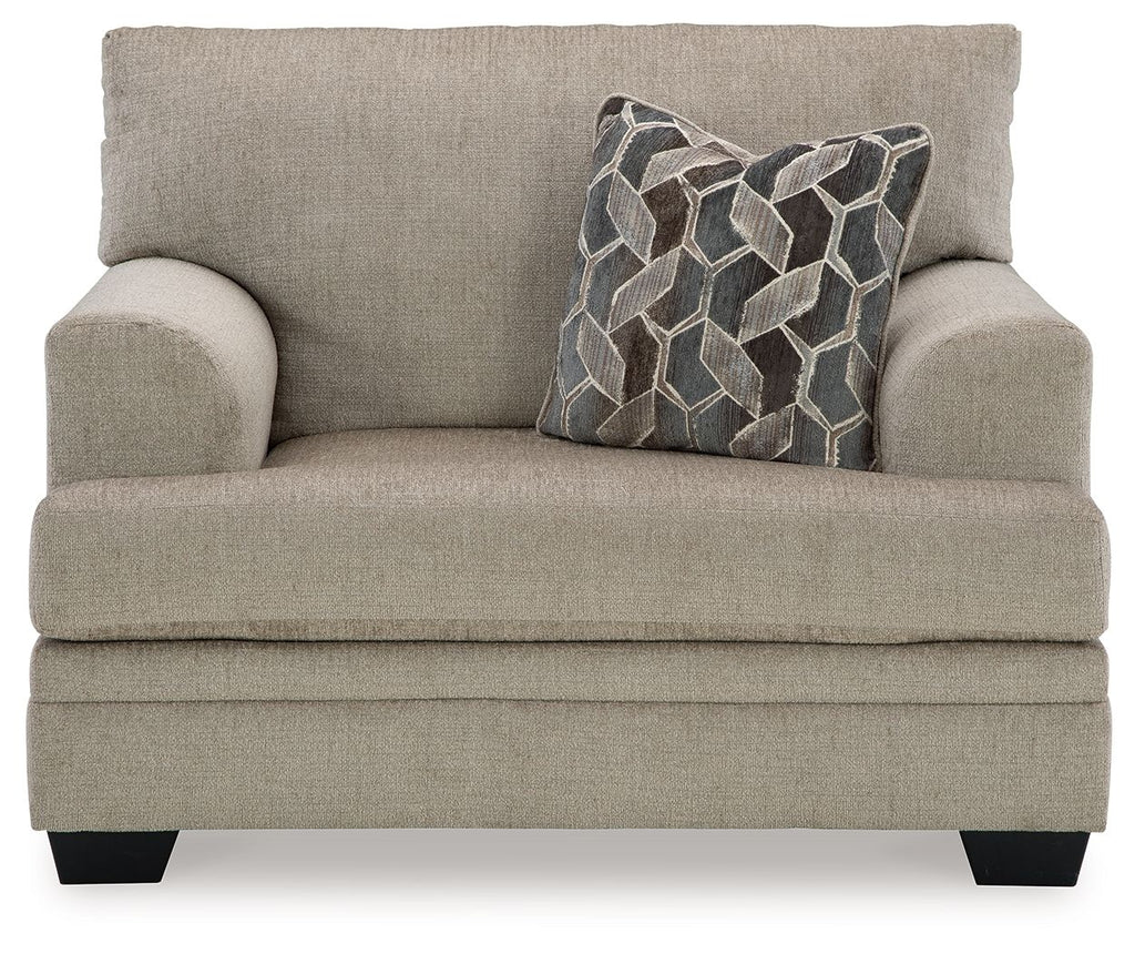 Upholstered loveseat-style sofa with seat cushion and back pillows, beige fabric