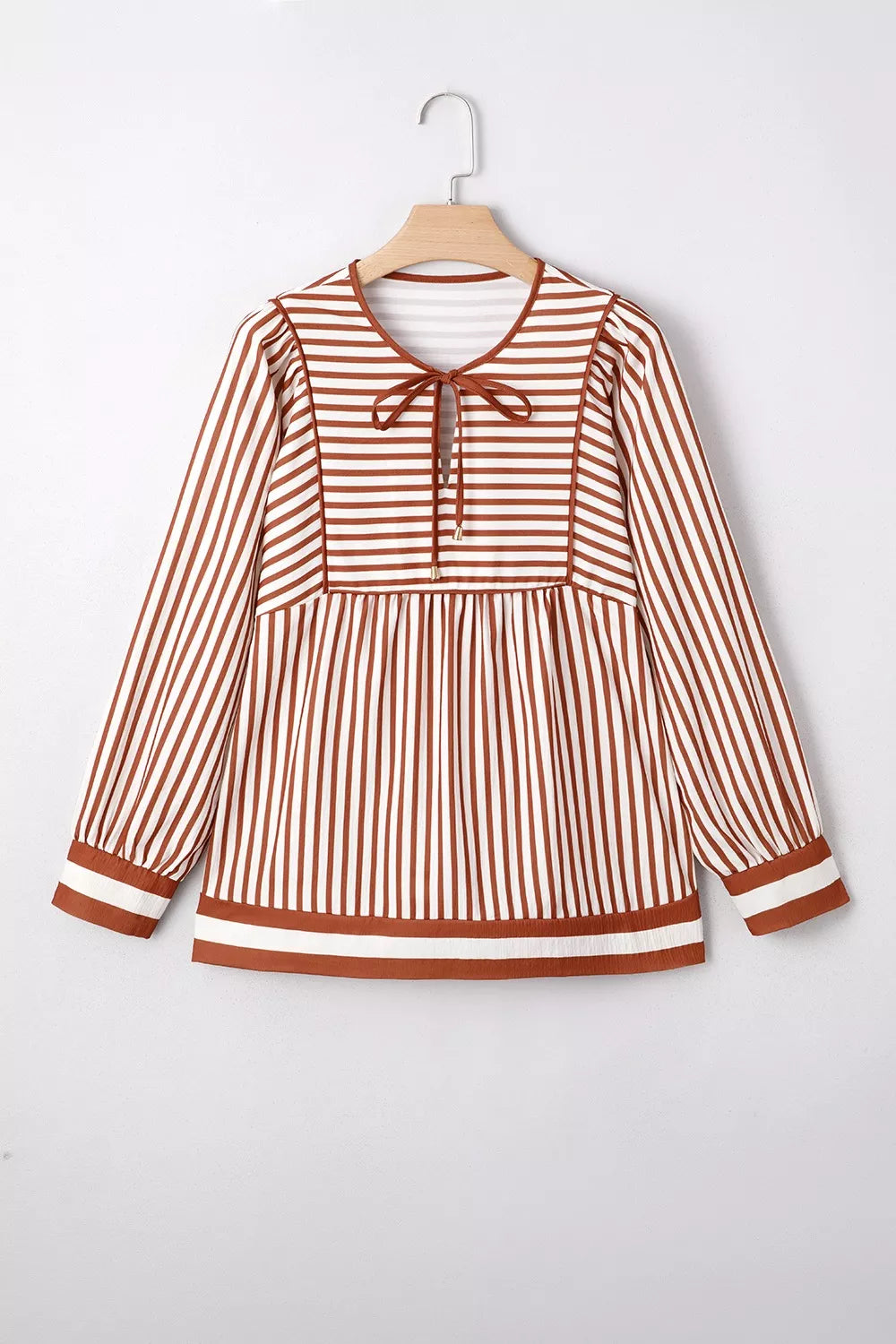 Striped babydoll long-sleeve blouse hanging with button placket and tiered body