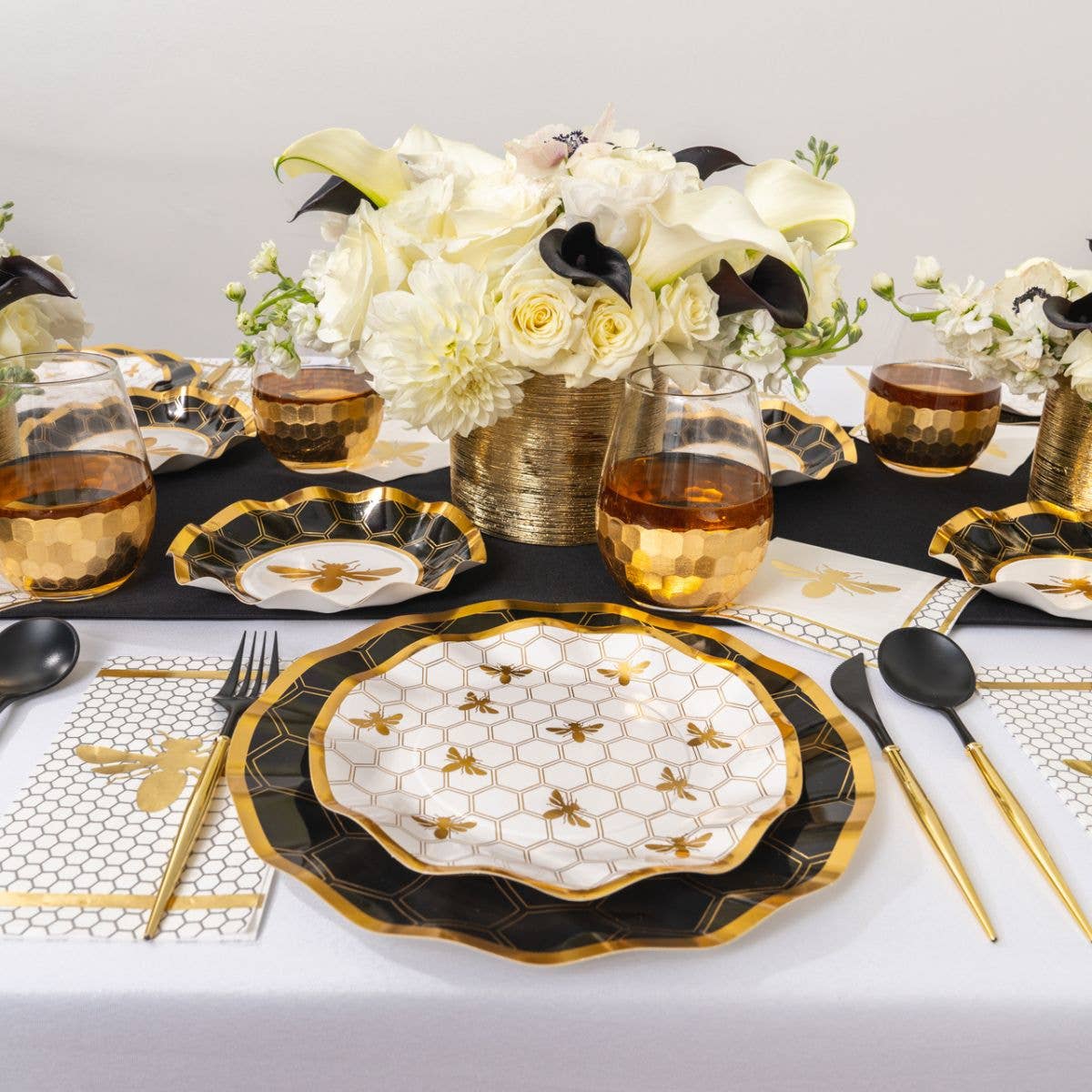 Wavy paper salad plate centerpiece, white honeycomb grid with gold bees and dark rim