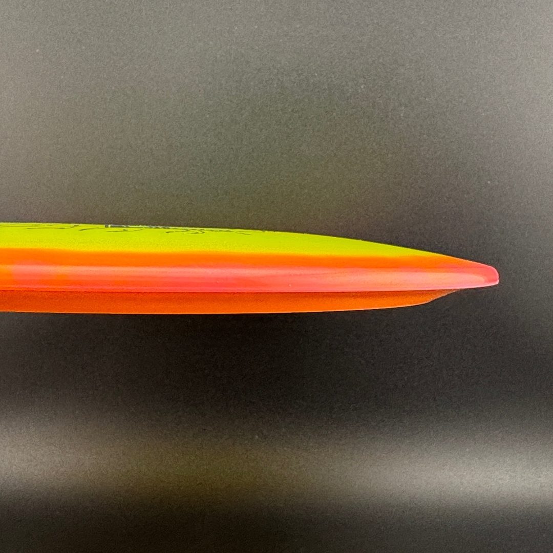 Orange disc golf driver side view with glossy rim and layered color edge