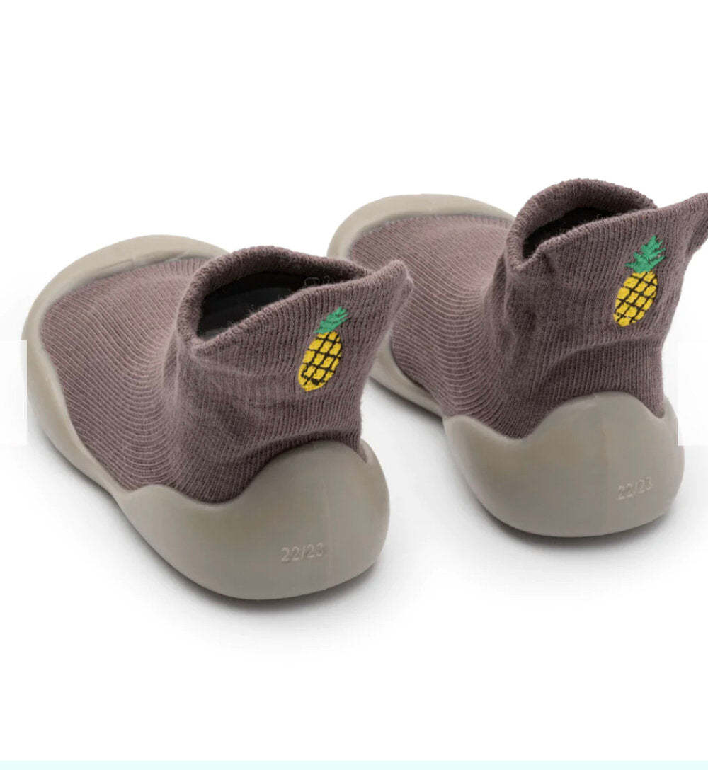 Taupe/gray barefoot sock shoes with embroidered pineapple patch and white sole.