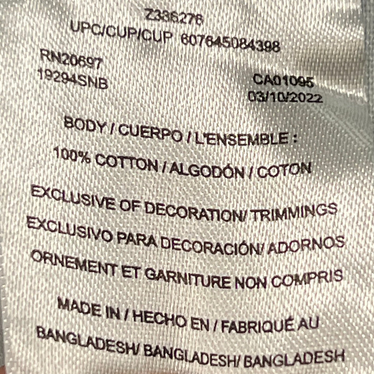 Interior care label with printed sizing and material information.