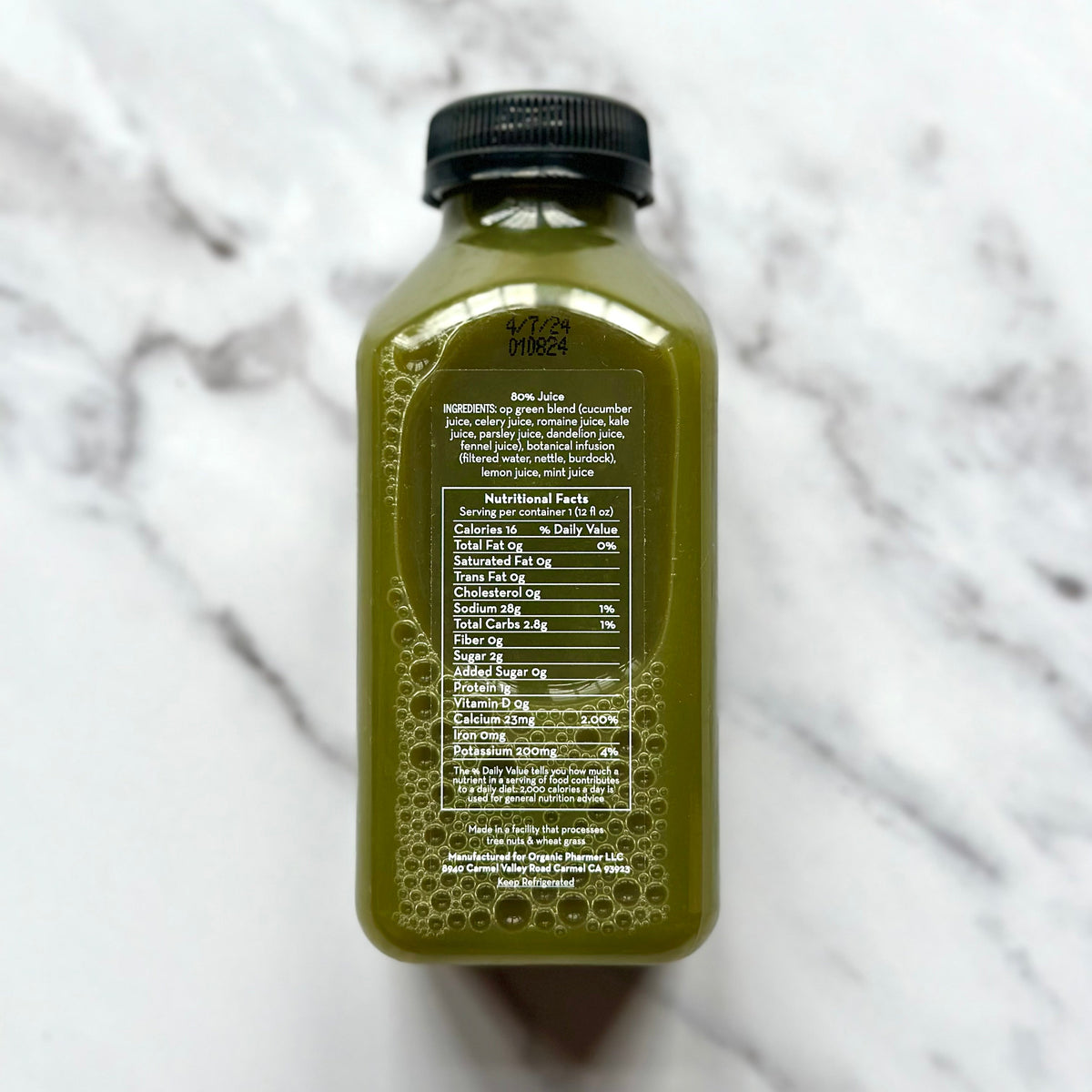 Organic green juice bottle with black cap, back nutrition facts panel