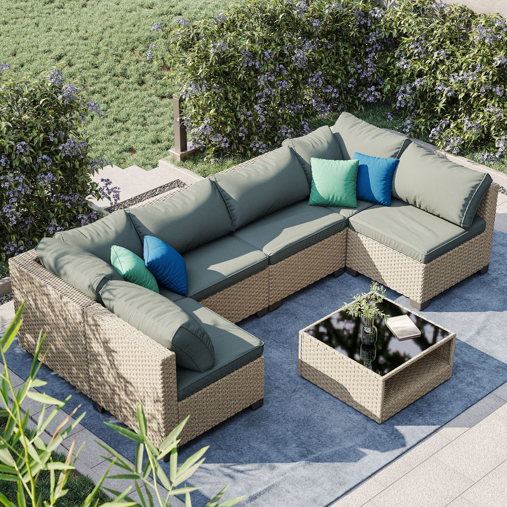 Beige sectional patio set with grey thick cushions, corner chaise, and coffee table