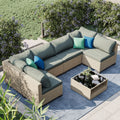 Beige sectional patio set with grey thick cushions, corner chaise, and coffee table
