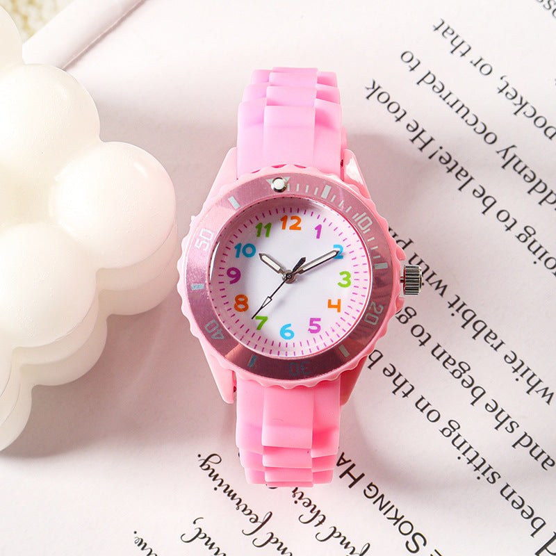 Pink kids analog wristwatch with silicone strap and colorful number dial