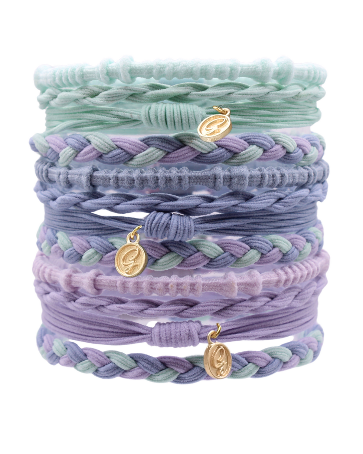 Stack of braided hair tie bracelets in mint, lavender, and lilac with gold charms