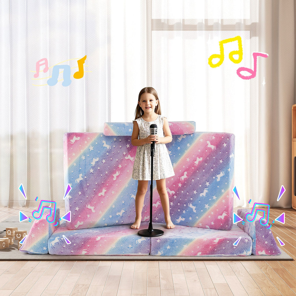 Kids play couch, galaxy star print pink-blue cushions, child standing on the seat