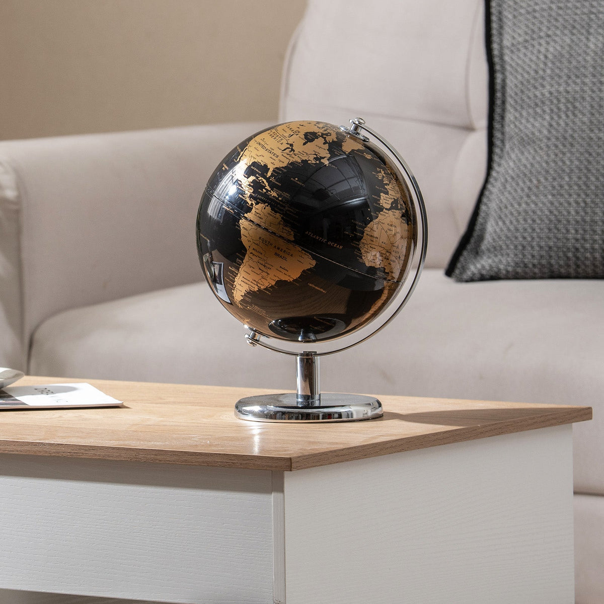 Tabletop decorative earth globe with gold-printed continents and chrome stand.