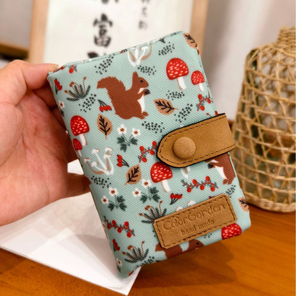 Printed tri-fold wallet with snap button, brown leather trim, fox and mushroom pattern