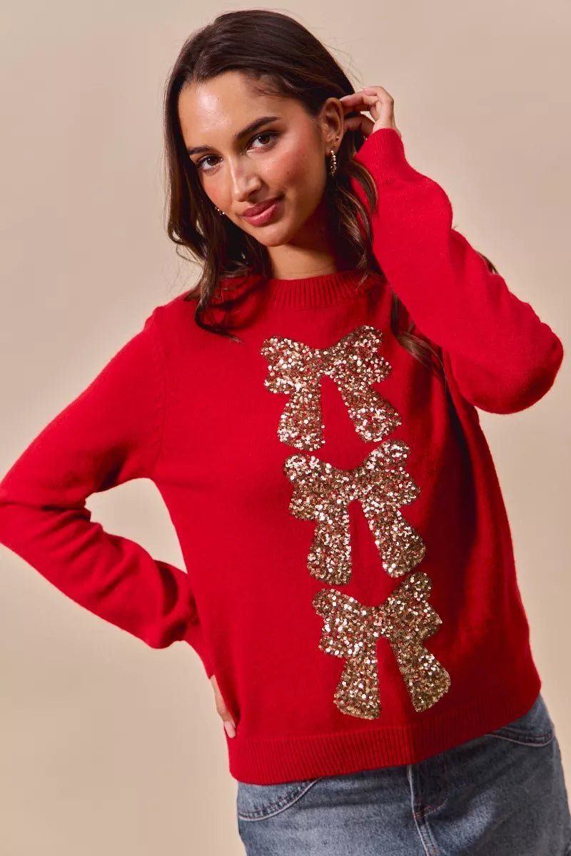 Red knit Christmas sweater with gold sequin bow ribbon design down front