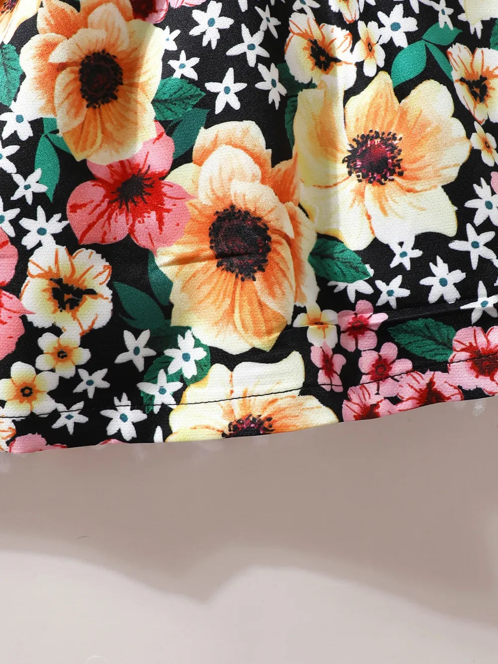 Floral ruffle skirt with multicolor blossoms on black background