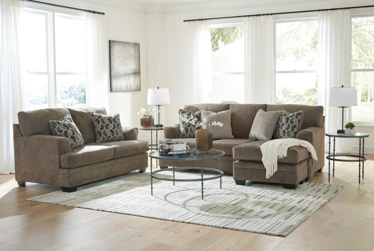 Stonemeade living room set with upholstered sofa, chaise, and ottoman in dark taupe