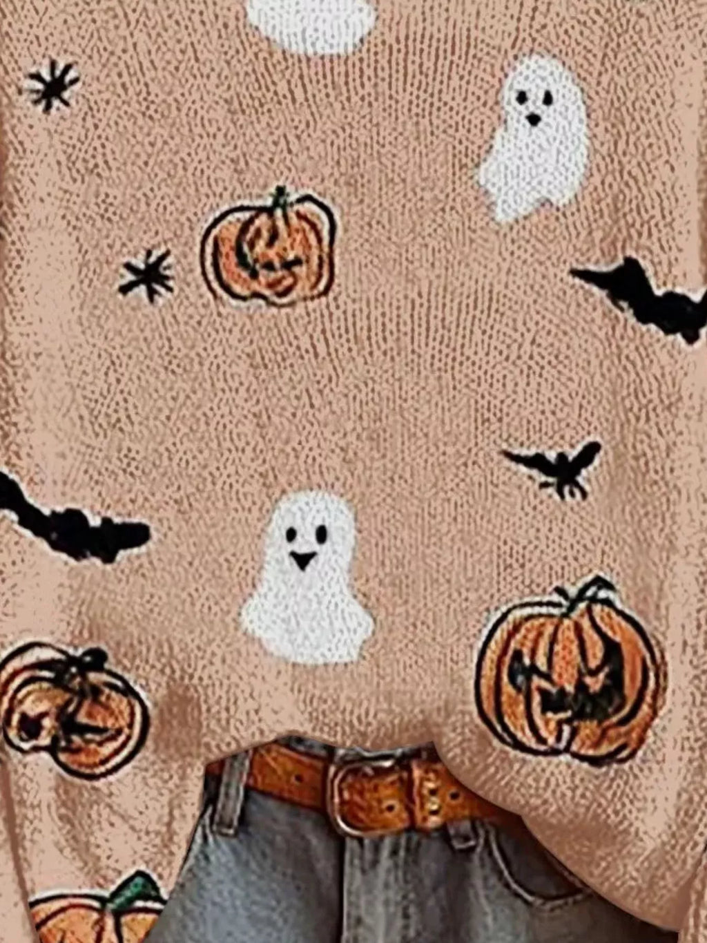 Pale blush Halloween sweater front close-up with ghost, pumpkin, and bat prints