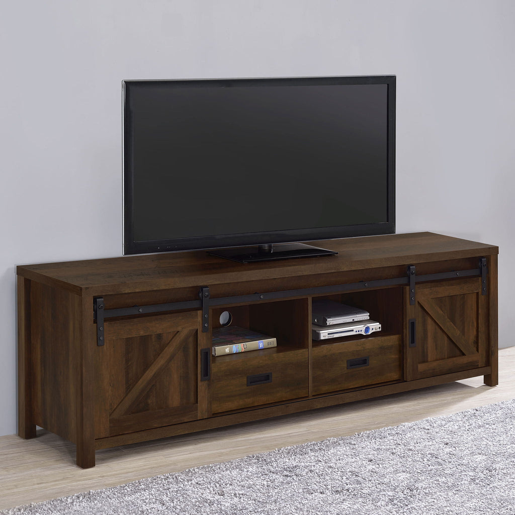 Dark pine TV stand with two doors, center shelves, and drawers; TV on top