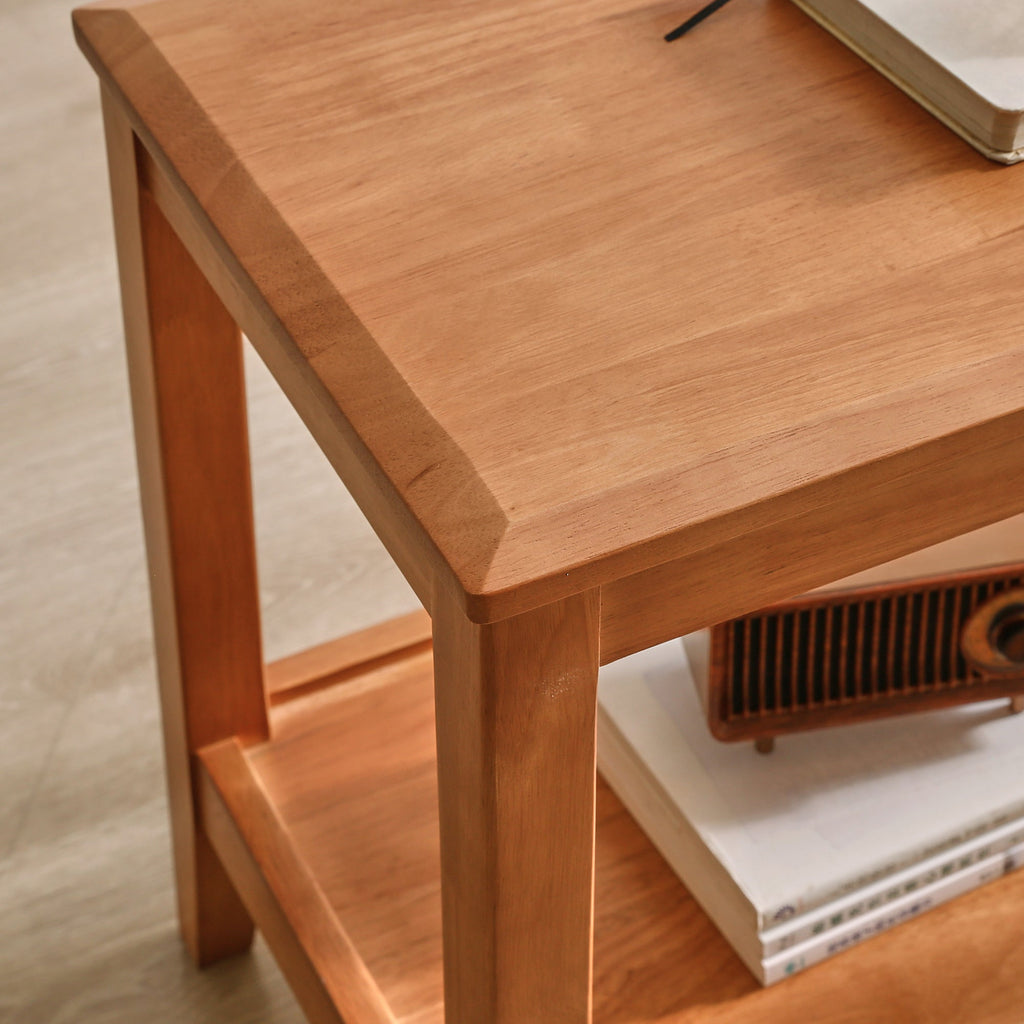 Close-up of wooden side table with beveled top edge and lower shelf