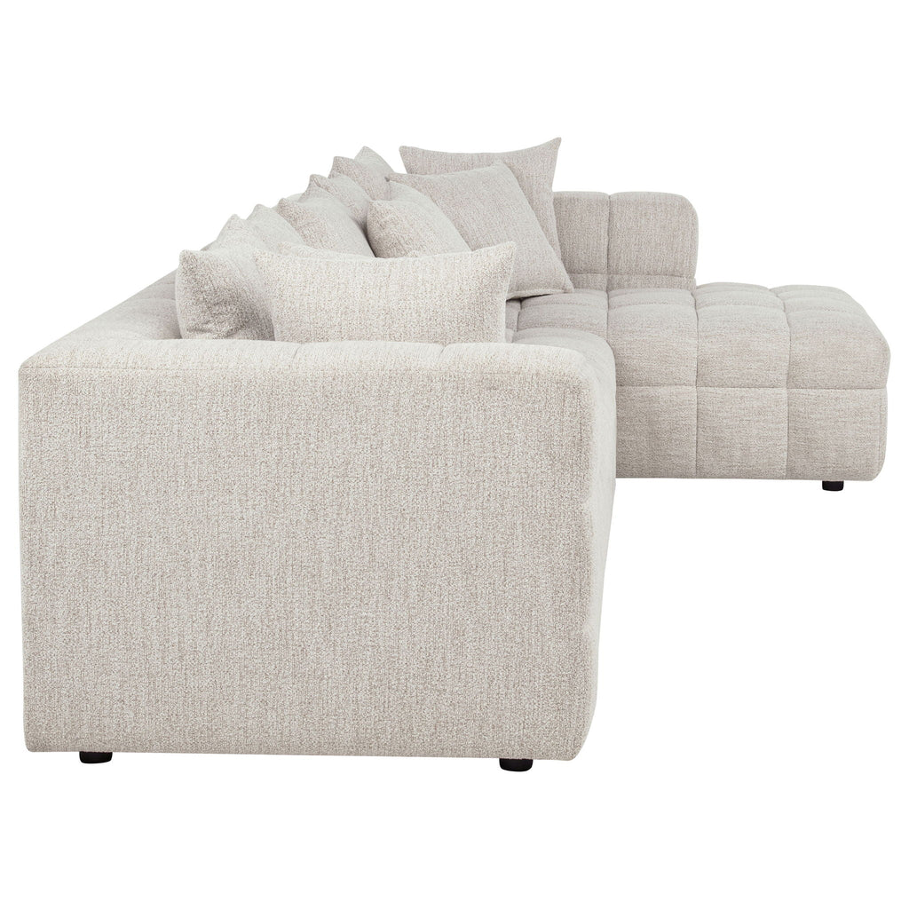 Light beige sofa chaise corner section with back cushions and textured upholstery