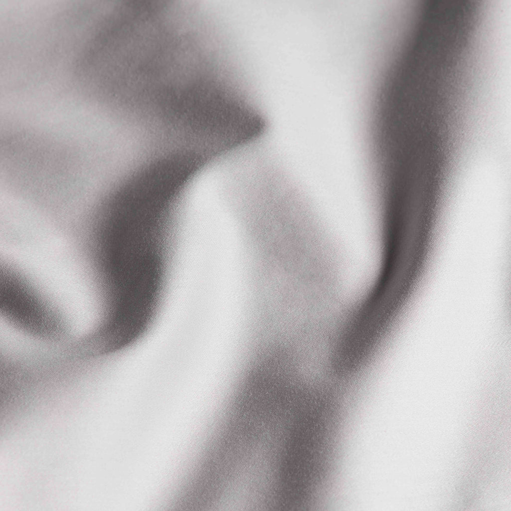 Light gray sateen fabric with smooth satin-like folds and sheen