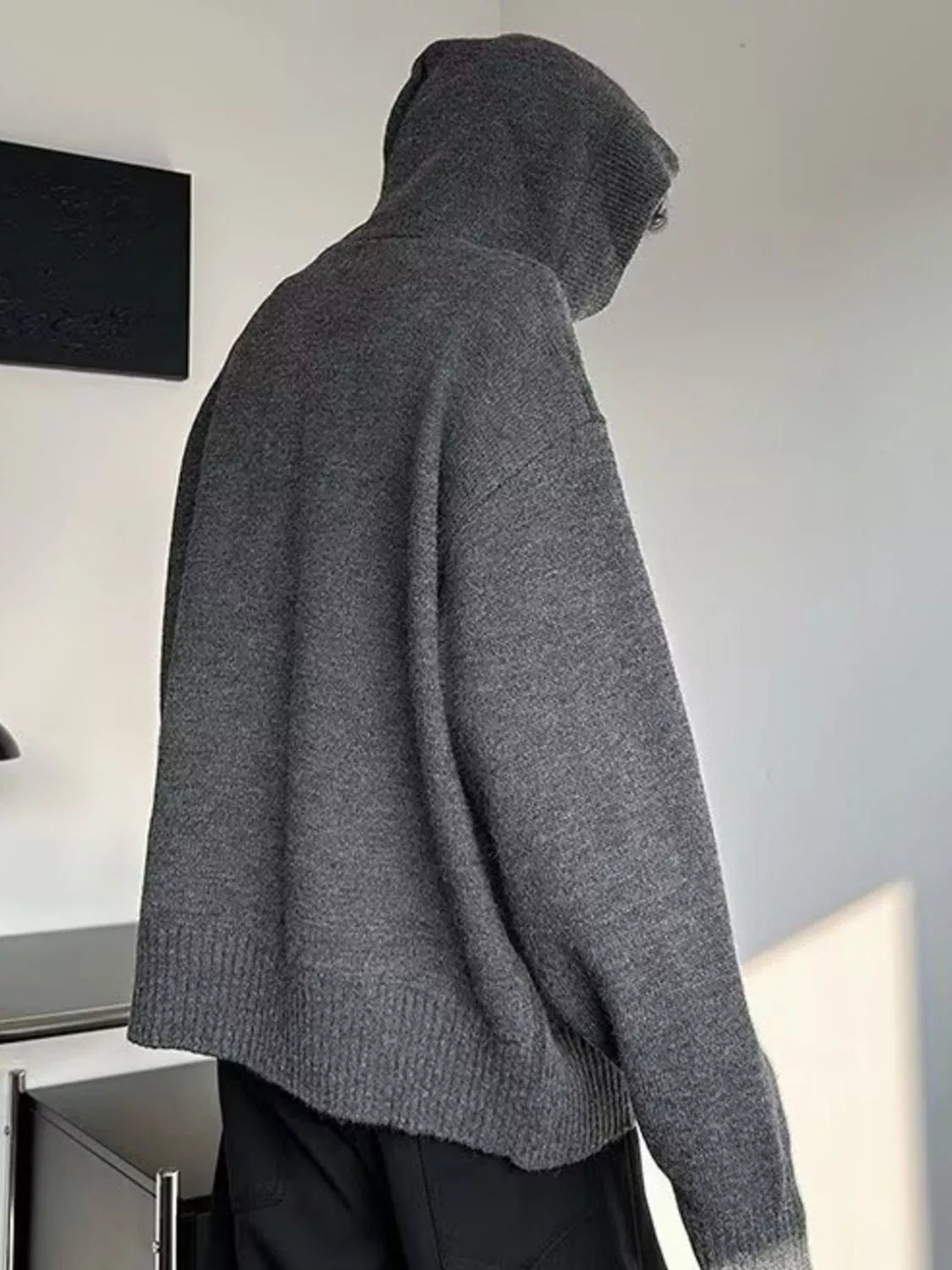 Gray knit hooded sweater back view with ribbed hem