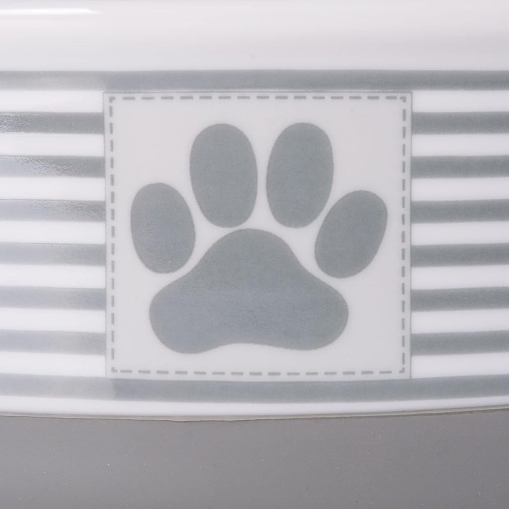 Close-up of gray paw-print badge on a striped ceramic pet bowl