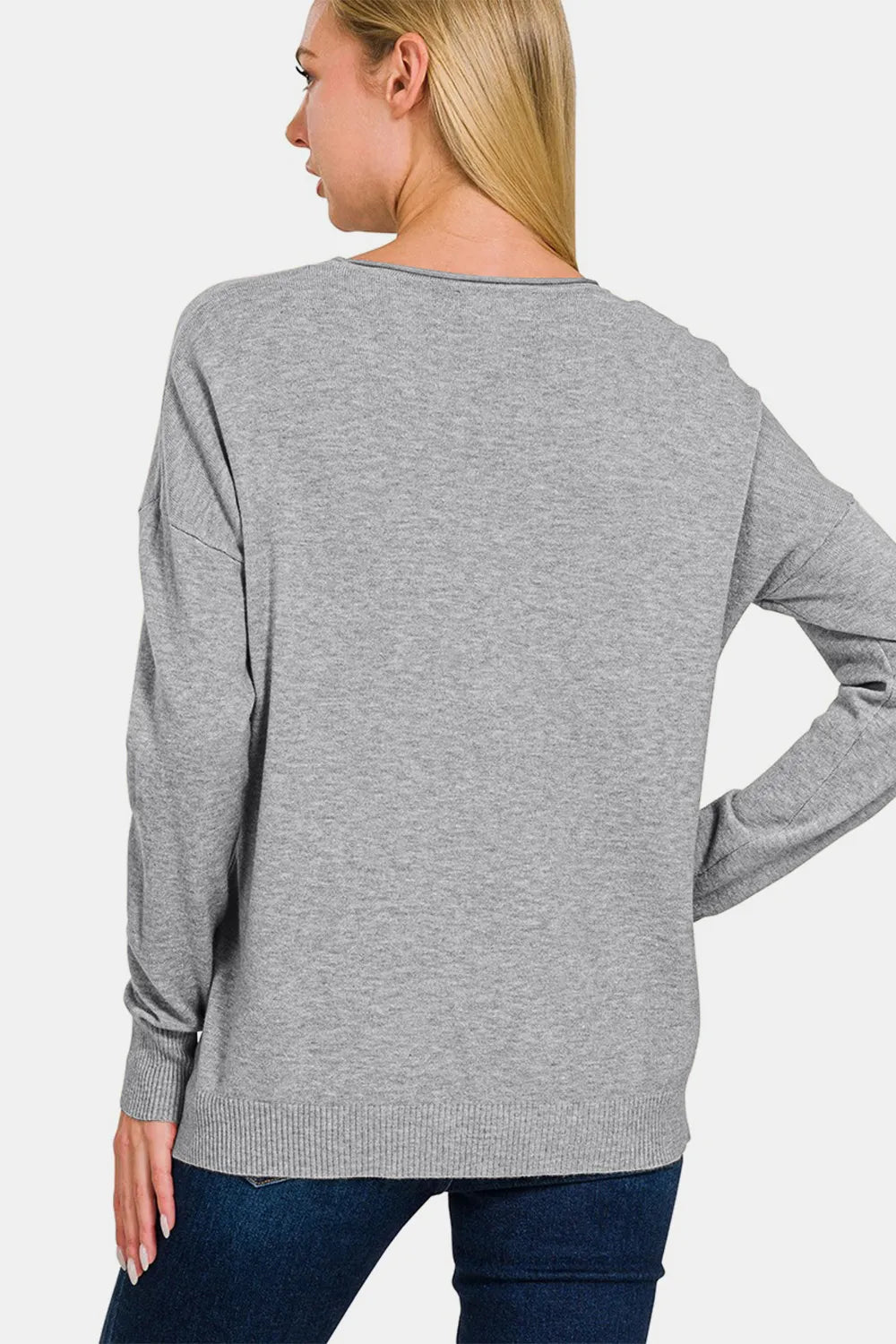 Gray round-neck sweater, back view with long sleeves and ribbed cuffs