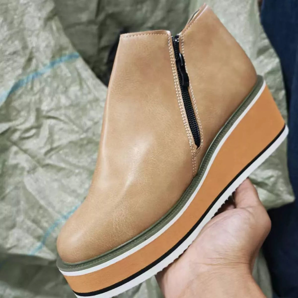 Tan ankle wedge boots with side zipper and green-trim striped sole